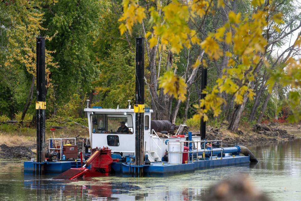 A hydraulic dredge removes sediment from a backwater of the Mississippi River Oct. 19 near Prairie du Chien. Once the area is dredged, the water will be deeper, improving habitat for overwintering fish. The sediment taken from the area will be used to raise the height of nearby islands so that the trees there can survive flooding.