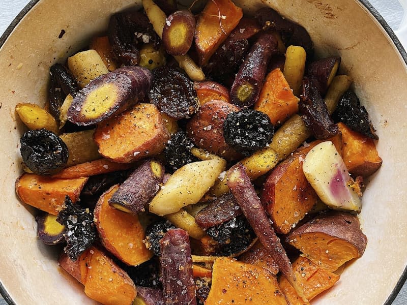 A photo of a serving bowl with a portion of Tzimmes (a traditional stew for Passover, made from a combination of sweet potatoes and dried fruit)