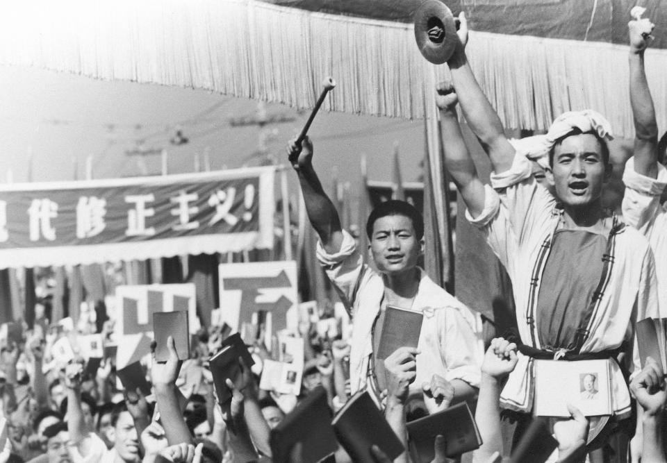 FILE - Drummers raise their cymbals and sticks as others hold up small booklets containing the writings of then Chairman Mao Zedong during a demonstration by Red Guard youth groups in front of the Soviet Embassy in Beijing Aug. 29, 1966. China’s leader Xi Jinping just concluded a three-day visit with Russian President Vladimir Putin, a warm affair in which the two men praised each other and spoke of a profound friendship. It’s a high in a complicated, centuries-long relationship in which the two countries have been allies and enemies. (AP Photo, File)