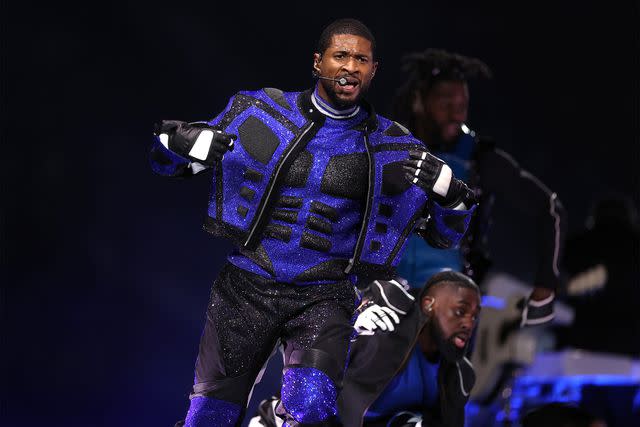 <p>Jamie Squire/Getty</p> Usher performs at the Super Bowl LVIII halftime show