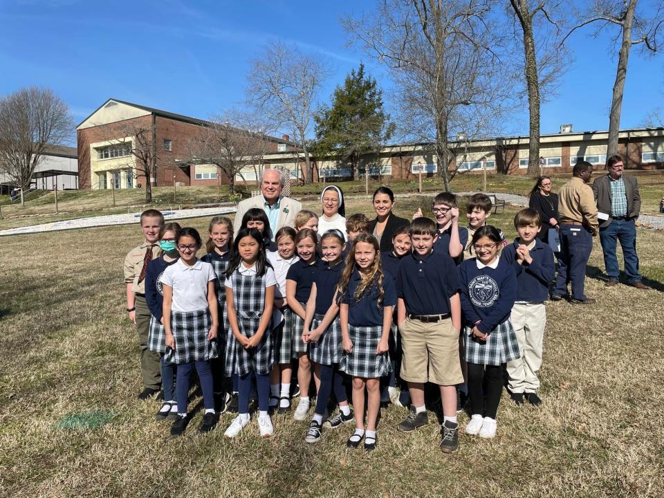 The 2022 Arbor Day observance in the city was held at St. Mary's School. Here Mayor Warren Gooch poses with students from the Catholic school.