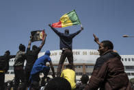 Demonstrators shout slogans during a protest against the arrest of opposition leader and former presidential candidate Ousmane Sonko near the Justice Palace of Dakar, Senegal, Monday, March 8, 2021. A Senegalese court cleared the way Monday for Sonko's release pending his rape trial in a case that already has sparked deadly protests and threatened to erode the country's reputation as one of West Africa's most stable democracies. (AP Photo/Sylvain Cherkaoui)