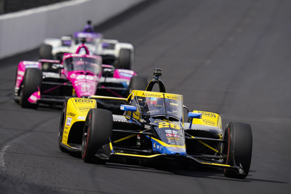 Colton Herta drives into the first turn during practice for the IndyCar auto race at Indianapolis Motor Speedway in Indianapolis, Thursday, May 19, 2022. (AP Photo/Michael Conroy)