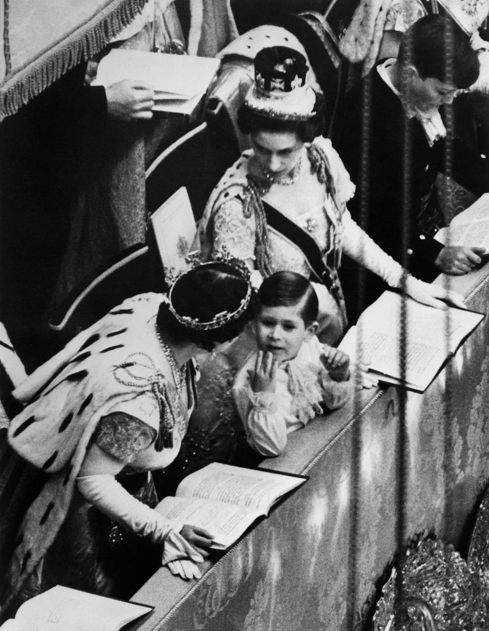 In this file photo taken on June 2, 1953 at London, in the Westminster abbey Prince Charles reacts during the coronation ceremony of his mother, Queen Elizabeth II. Trained from childhood to be king, Charles III has endured the longest wait for the throne in British history. He has spent virtually his entire life waiting to succeed his mother. Their coronations, separated by 70 years, differ in style, size, tone and mission.