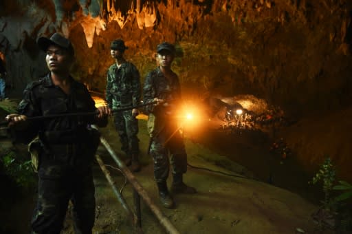 Thai soldiers relay electric cable deep into the Tham Luang cave, which is infamous for its complicated network of tunnels and pools