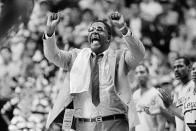 FILE - In this March 30, 1985, file photo, Georgetown coach John Thompson shouts to the floor during the Hova's NCAA semifinal game against St. John's at Rudo Arena in Lexington, Ky. John Thompson, the imposing Hall of Famer who turned Georgetown into a “Hoya Paranoia” powerhouse and became the first Black coach to lead a team to the NCAA men’s basketball championship, has died. He was 78 His death was announced in a family statement Monday., Aug. 31, 2020. No details were disclosed. (AP Photo/File)