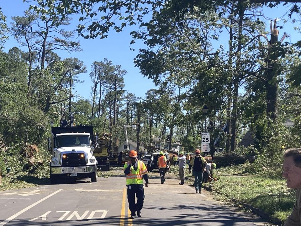Crews clean up in Virginia Beach, Va., Monday May 1, 2023 the day after a tornado struck the city. (AP Photo/Ben Finley)