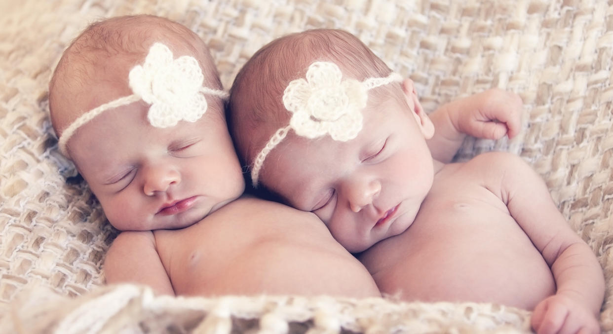 The twins, depicted here by models, finally met 27 days after they were born. [Photo: Getty]