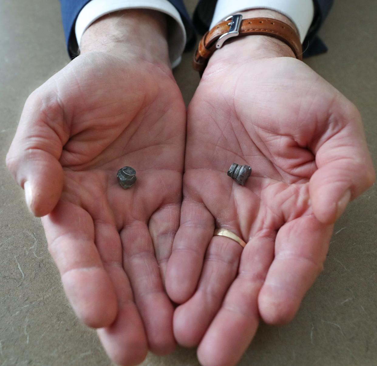 Funeral director David Anthony holds the bullets that killed his parents. When asked why he keeps them, he says: "They're kind of relics, I guess. They're an important part of the story. I mean, they're real. ... To look at those is to say 'That's what a bullet does.'"