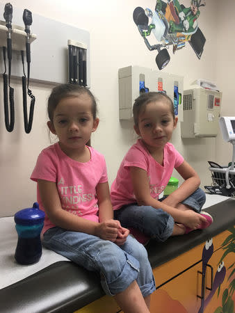 Janna Driver's twin daughters Birella (R) and Camila are pictured in hospital in Oklahoma City, Oklahoma, U.S. in this August 13, 2018 handout photo obtained by Reuters December 11, 2018. A pediatrician diagnosed the twins with chronic upper respiratory infections – a symptom of mold exposure from their house at Tinker Air Force Base. Janna Driver/Handout via REUTERS