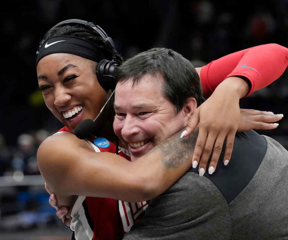 March 25, 2023; Seattle, WA, USA; Ohio State Buckeyes head coach Kevin McGuff embraces Ohio State Buckeyes forward Cotie McMahon (32) as she is interviewed by media following a 73-61 win over UConn Huskies in an NCAA Tournament Sweet Sixteen game at Climate Pledge Arena in Seattle on Saturday. Ohio State advances to the Elite Eight. Mandatory Credit: Barbara J. Perenic/Columbus Dispatch