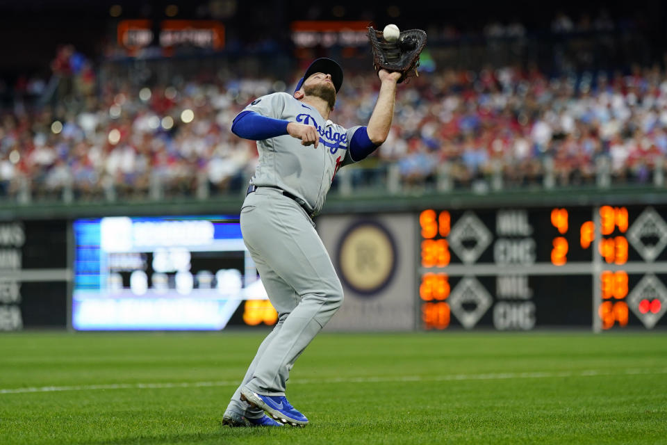Los Angeles Dodgers first baseman Max Muncy catches pop foul out by Philadelphia Phillies' J.T. Realmuto during the second inning of a baseball game, Tuesday, Aug. 10, 2021, in Philadelphia. (AP Photo/Matt Slocum)