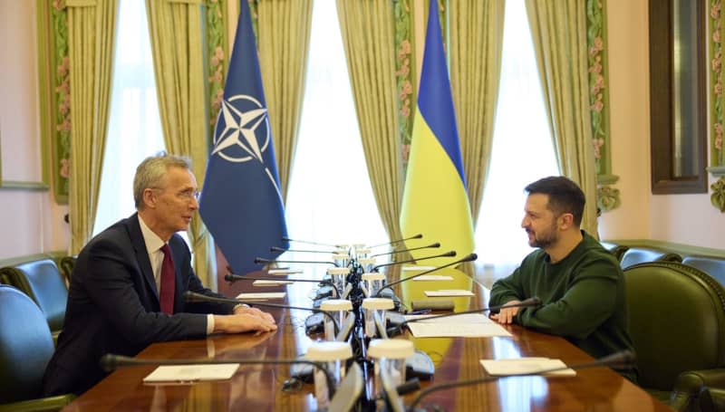 NATO Secretary General Jens Stoltenberg and President Volodymyr Zelenskyy of Ukraine attend a meeting. "The lack of ammunition has enabled the Russians to push forward along the front line," Stoltenberg said, singling out the United States for Washington's protracted process to send more military aid. -/NATO/dpa