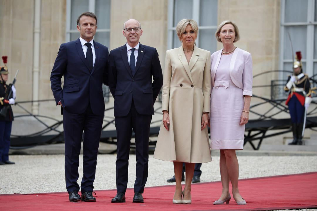 France's President Emmanuel Macron (L) and his wife Brigitte Macron (2-R) greet  Luxembourg's Prime Minister Luc Frieden (2-L) and his wife Marjolijne Droogleever-Fortuyn (R) on arrival ahead of a reception for heads of state and governments ahead of the opening ceremony of the Paris 2024 Olympic Games, at the Elysee presidential palace in Paris, on July 26, 2024. (Photo by Valentine CHAPUIS / AFP) (Photo by VALENTINE CHAPUIS/AFP via Getty Images)