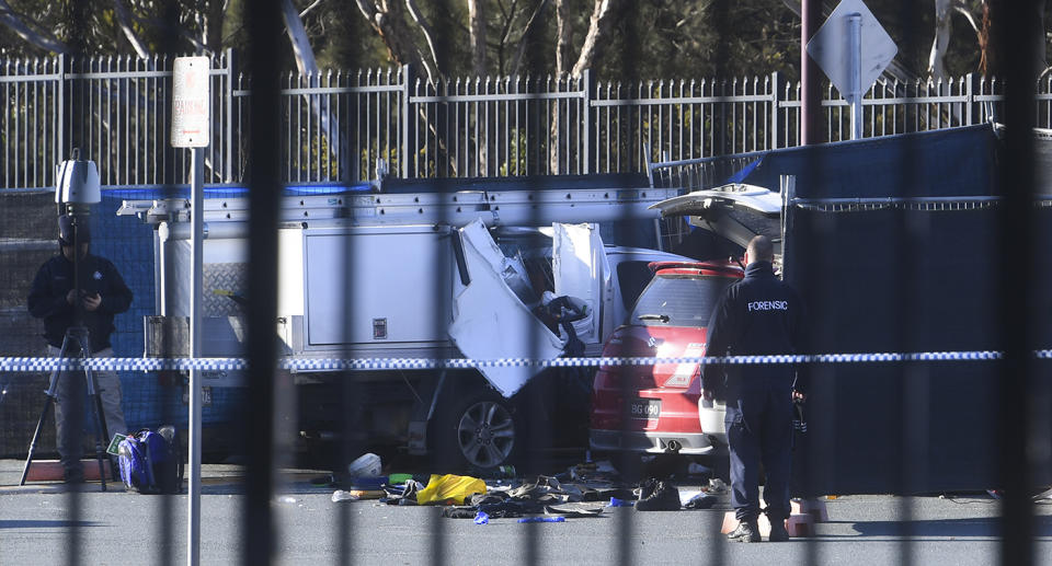 Forensic Police investigate a car damaged by an explosion in the car park of St Clare of Assisi Primary School in Canberra. Source: AAP