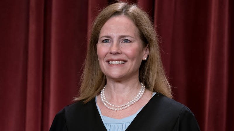 Associate Justice Amy Coney Barrett joins other members of the Supreme Court as they pose for a new group portrait, at the Supreme Court building in Washington, Friday, Oct. 7, 2022.
