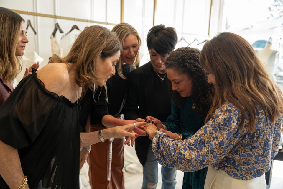 From left: Theresa’s daughter, Jen Woolston; Golden Bachelor contestant Kathy “Zip It” Swarts; Gerry’s daughter Jenny Young; Susan Noles; Gerry’s daughter Angie Warner; and Theresa Nist admire the ring during a dress-shopping trip in this exclusive image ahead of Thursday’s wedding.