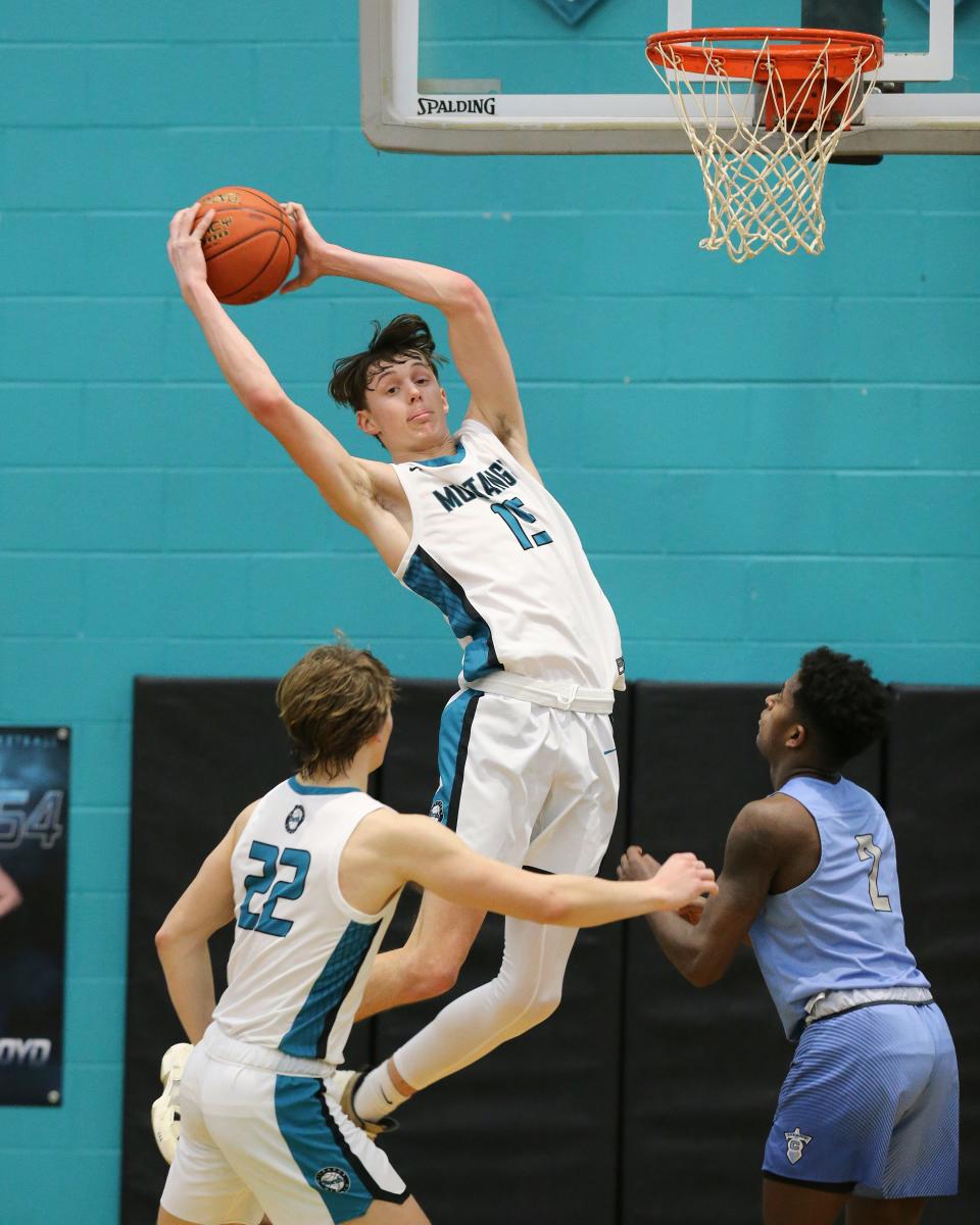 North Oldham's Luke Anderson (15) goes high for a rebound against Collins during their game at North Oldham High School in Goshen, Ky. on Feb. 14, 2023.