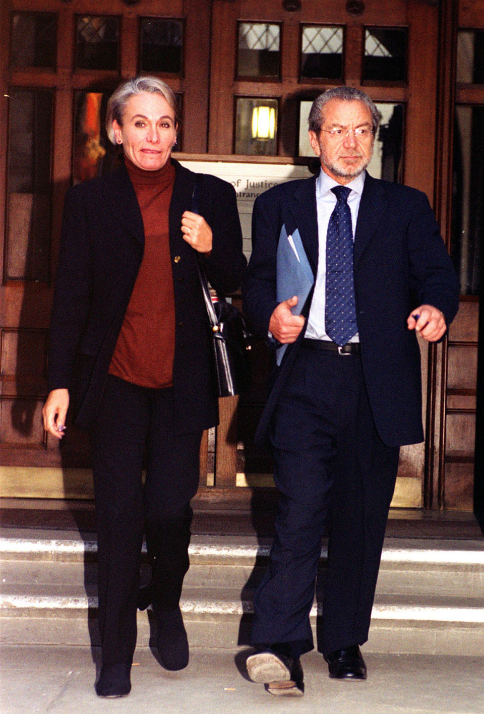 Sir Alan Sugar (right) with a companion leaving the High Court in London. A High Court jury was, expected to retire to consider its verdict on the libel action by Tottenham chairman Sir Alan Sugar over a newspaper article which dubbed him miserly.  *.. in his stewardship of the soccer club. The 53-year-old multi-millionaire businessman is suing the Daily Mail over a December 1999 story which said he should come out of his counting house and give manager George Graham the cash to buy top players.  