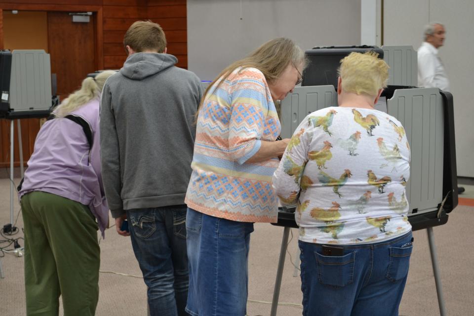 Nancy Wilson, right, an election worker, helps a resident fill out their ballot during Tuesday's primary election, May 3, 2022.