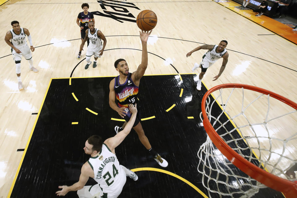 Phoenix Suns' Cameron Payne (15) shoots over Milwaukee Bucks' Pat Connaughton (24) during the first half of Game 1 of basketball's NBA Finals, Tuesday, July 6, 2021, in Phoenix. (Christian Petersen/Pool Photo via AP)