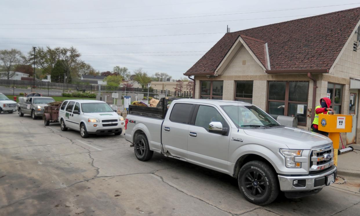 Damond Watts hands out payment receipts to those recycling unwanted goods, debris, electronics, tires and more Tuesday, May 4, 2021, at the Northside Drop Off Center Location at 6660 N. Industrial Road, Milwaukee.