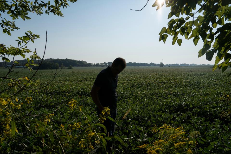 Brian Zoeller stands in the field that Becknell Industrial is planning to build their new warehouse Wednesday, Sept. 14, 2022, near Acton, Ind. The field and the surrounding area is already a floodplain. Zoeller and his neighbors are worried the warehouse will worsen the flooding and damage their properties.