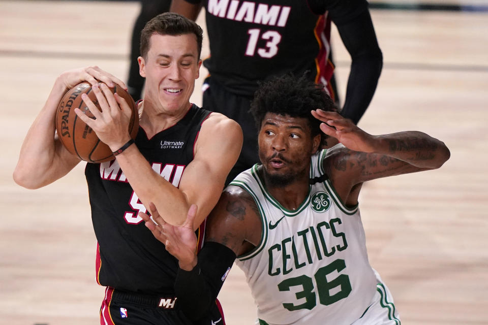 Miami Heat's Duncan Robinson, left, battles for the ball with Boston Celtics' Marcus Smart (36) during the second half of an NBA conference final playoff basketball game Sunday, Sept. 27, 2020, in Lake Buena Vista, Fla. (AP Photo/Mark J. Terrill)