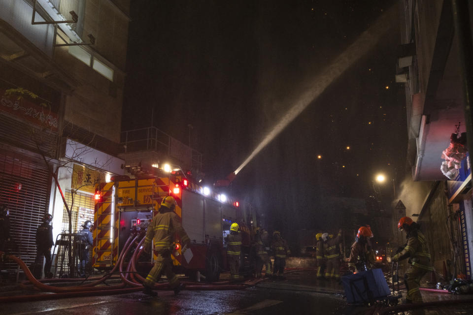 Firefighters battle a fire at a construction site in Hong Kong, Friday, March 3, 2023. Hong Kong firefighters are battling the blaze that broke out at a construction site in the city's popular shopping district. (AP Photo/Louise Delmotte)