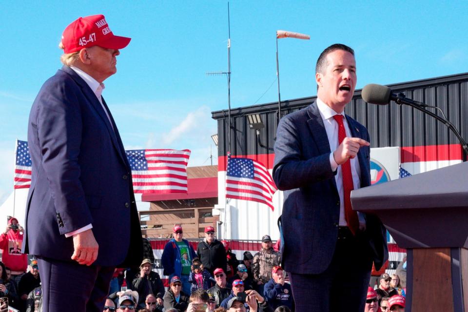 PHOTO: Republican presidential candidate and former President Donald Trump, left, listens as Senate candidate Bernie Moreno speaks at a campaign rally March 16, 2024, in Vandalia, Ohio.  (Jeff Dean/AP)