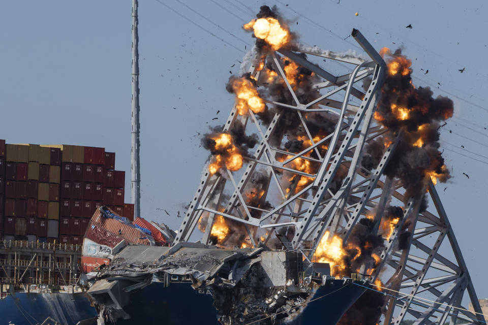 Explosive charges are detonated to bring down sections of the collapsed Francis Scott Key Bridge resting on the container ship Dali on Monday, May 13, 2024, in Baltimore. (AP Photo/Mark Schiefelbein)