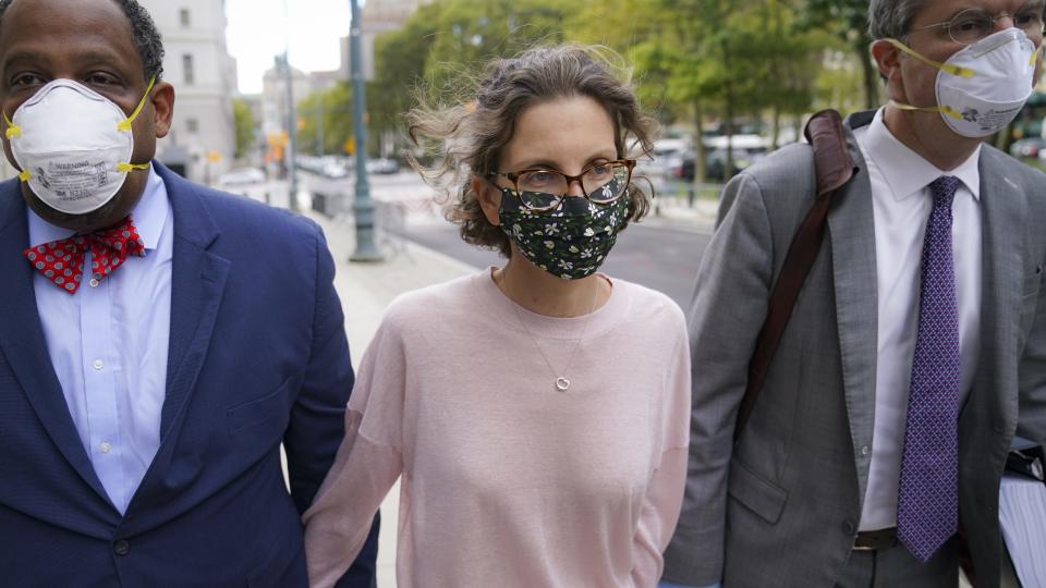 Clare Bronfman arrives at federal court, Wednesday, Sept. 30, 2020, in the Brooklyn borough of New York. Bronfman, the Seagram's liquor fortune heir and a wealthy benefactor of Keith Raniere, the disgraced leader of a self-improvement group NXIVM in upstate New York convicted of turning women into sex slaves who were branded with his initials, faces sentencing Wednesday in the federal conspiracy case. (AP Photo/John Minchillo)