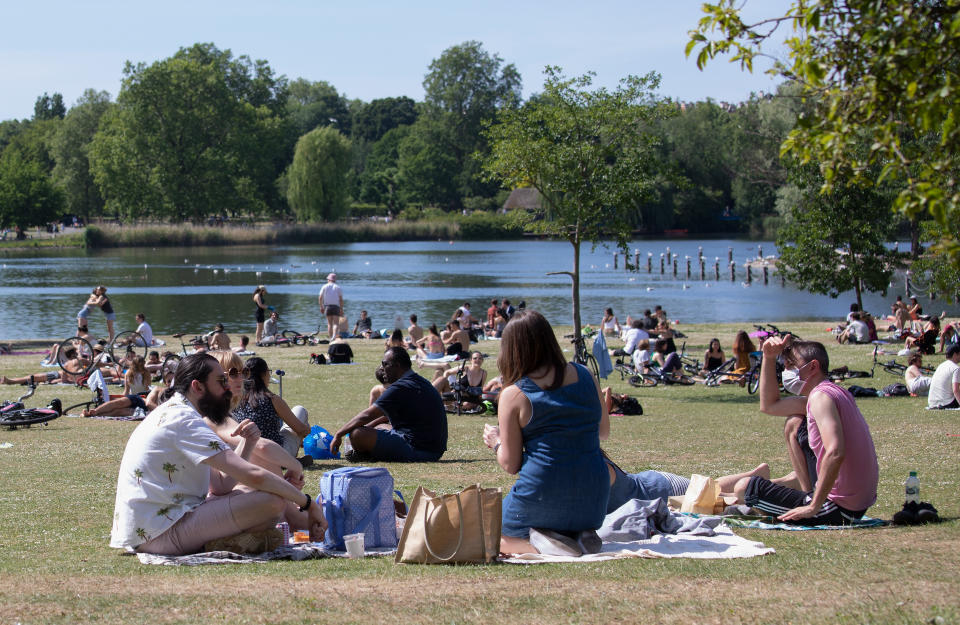 LONDON, ENGLAND - MAY 25: Members of the public sunbathing by the lake on a sunny Bank Holiday Monday in Regents Park on May 25, 2020 in London, England. The British government has started easing the lockdown it imposed two months ago to curb the spread of Covid-19, abandoning its 'stay at home' slogan in favour of a message to 'be alert', but UK countries have varied in their approaches to relaxing quarantine measures. (Photo by Jo Hale/Getty Images)