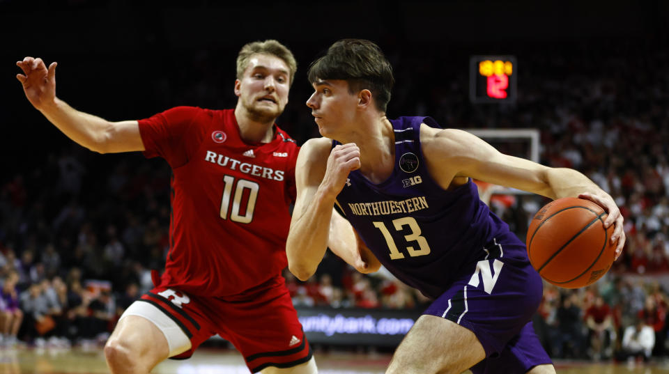 Northwestern guard Ty Berry drives to the basket against Rutgers guard Cam Spencer (10) during the first half of an NCAA college basketball game, Sunday, Mar.5, 2023 in Piscataway, N.J. (AP Photo/Noah K. Murray)