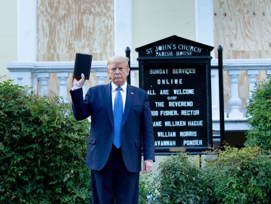 US President Donald Trump holds a Bible while visiting St. John's Church across from the White House after the area was cleared of people protesting the death of George Floyd June 1, 2020, in Washington, DC