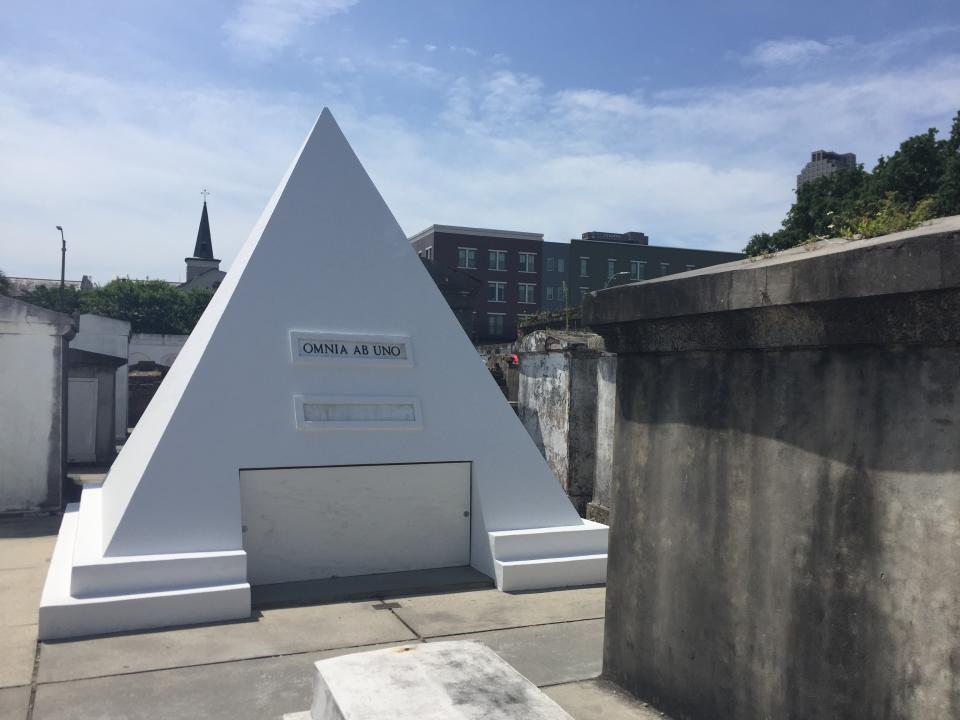Actor Nicolas Cage is alive and well but he owns this gleaming tomb shaped like a pyramid in St. Louis Cemetery No. 1 in New Orleans, pictured in this June 3, 2018 photo. The white 9-foot-tall structure bears the words "omnia ab uno," which is Latin for "everything from one." (AP Photo/Beth J. Harpaz)