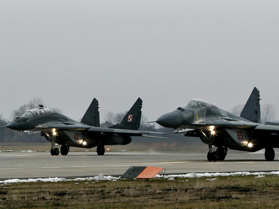 Polish MiG's-29 take off for a training mission at the military airport near Minsk Mazowiecki, east of Warsaw, December 6, 2005. As part of a rotational duty shared by members of the military alliance, Poland's MiGs will begin "air policing" missions over Estonia, Latvia and Lithuania in January. REUTERS/Peter Andrews