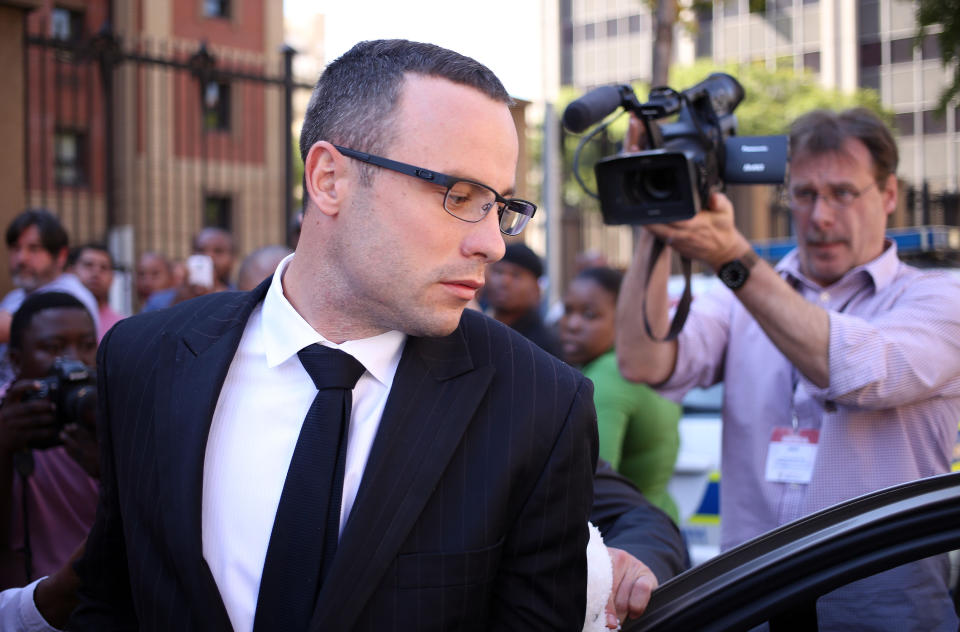 Oscar Pistorius leaves the high court in Pretoria, South Africa, Tuesday, May 13, 2014. Pistorius is charged with murder for the shooting death of his girlfriend, Reeva Steenkamp, on Valentines Day in 2013. (AP Photo/Themba Hadebe)