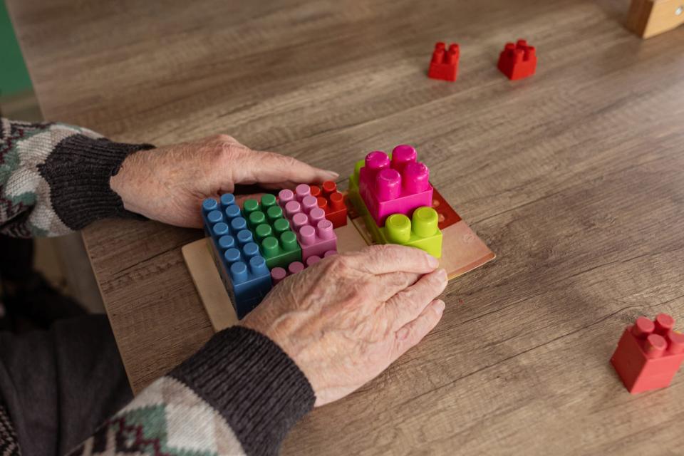 older man doing puzzle