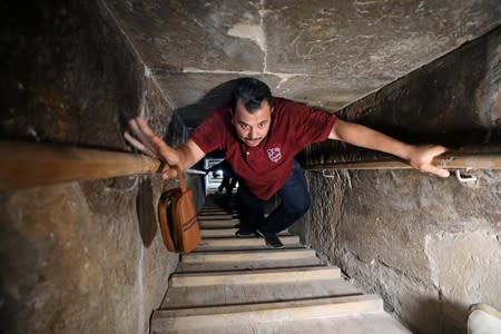 A man walks through a passage into the Bent Pyramid of Sneferu, that was reopened after restoration work, in Dahshur, south of Cairo