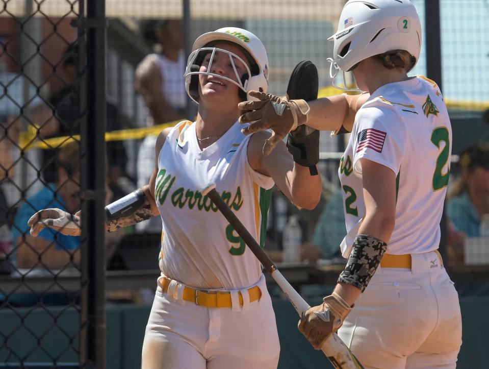 Jupiter's Emma Lucchesi (2) congratulates London Gomes (9) during the Class 7A state softball semifinal game between Jupiter High School and Davie Western High School at Legends Way Ballfields in Clermont on Friday, May 24, 2024. [PAUL RYAN / CORRESPONDENT]