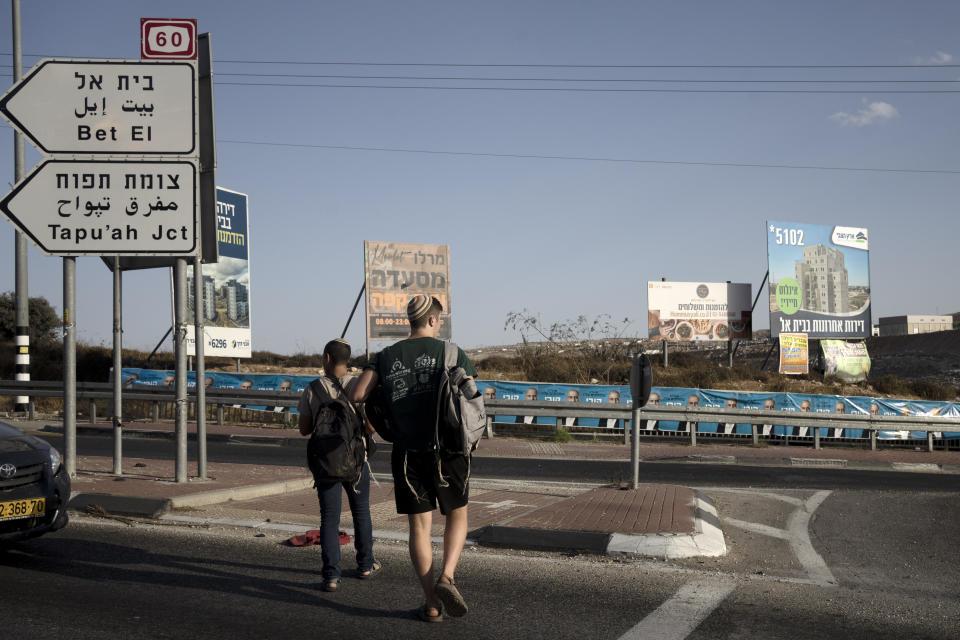 Billboards advertising new settlement housing construction are displayed prominently on Route 60 near the West Bank settlement of Kochav Yaakov, Monday, Sept. 11, 2023. Israel's finance minister Bezalel Smotrich — a staunch supporter of settlements that most of the international community considers a breach of international law — assumed new powers from the military over the occupied territory this year. As the first minister to oversee civilian life in the West Bank, his role amounts to a recognition that Israel's occupation is not temporary, but permanent, observers say. (AP Photo/Maya Alleruzzo)