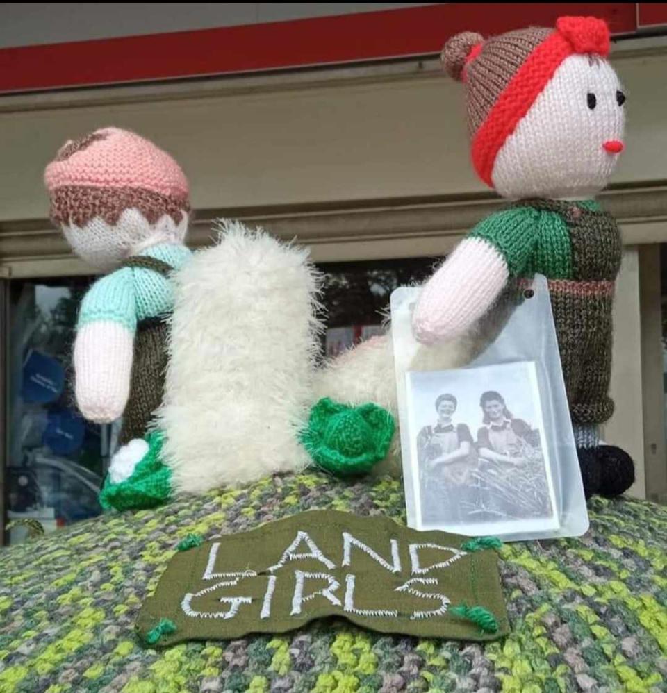 Crocheted figures on top of postbox 