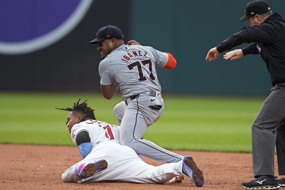 Cleveland Guardians' José Ramírez, left, slides safely into second base with a double as Detroit Tigers second baseman Andy Ibáñez (77) takes the throw during the fifth inning of a baseball game Tuesday, May 7, 2024, in Cleveland. (AP Photo/Sue Ogrocki)