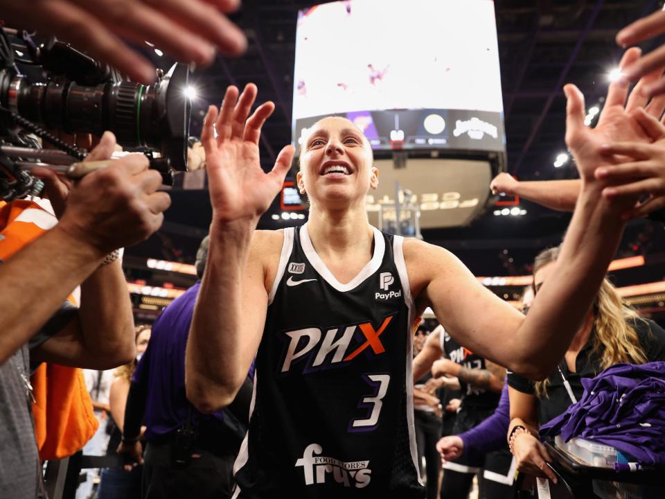 Diana Taurasi high-fives fans after her Phoenix Mercury's victory in Game 2 of the 2021 WNBA Finals.