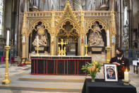 A photograph of Britain's Prince Philip, the Duke of Edinburgh, is displayed alongside the nave at Westminster Abbey, London, Saturday April 10, 2021, which has been dressed in black to mark his death. (Dominic Lipinski/PA via AP)