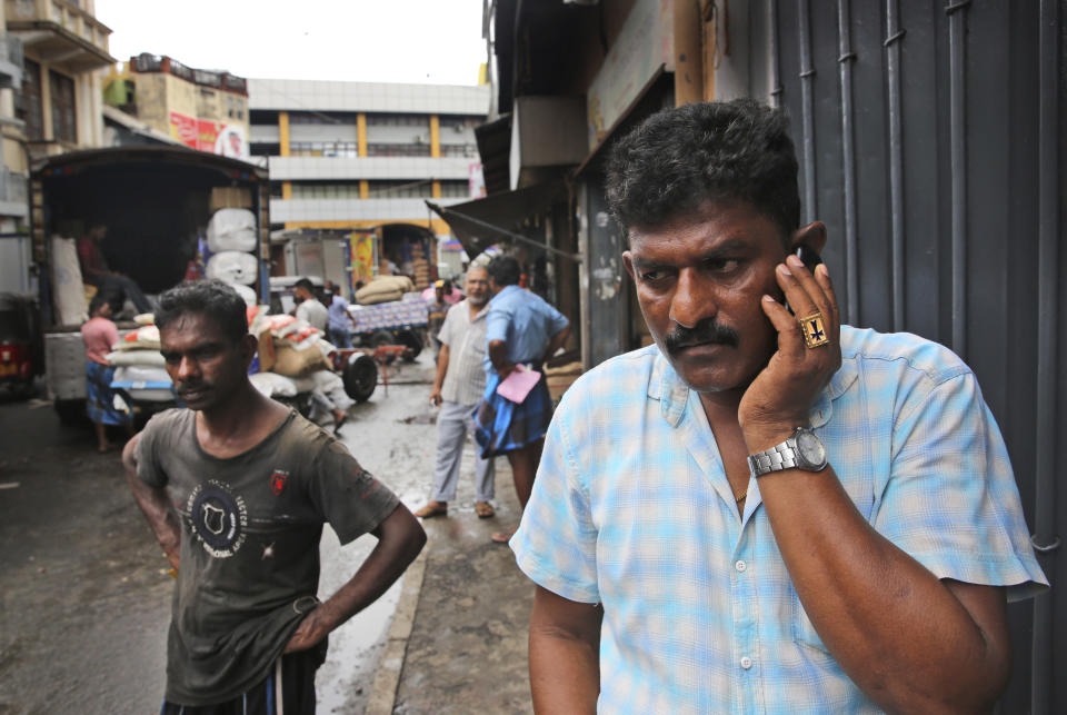 A Sri Lankan Christian trader talks on his mobile in a whole sale market in Colombo, Sri Lanka, Tuesday, April 30, 2019. Sri Lanka is limping back to normalcy after the devastating bomb attacks on Easter Sunday that killed more than 250 people and wounded hundreds more. People and vehicles are slowly coming back on the road and shops are open but traders say that their business remain drastically low. (AP Photo/Manish Swarup)