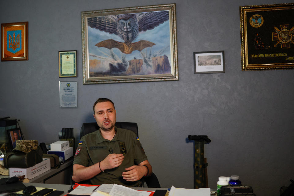Kyrylo Budanov sits behind a desk in an office.