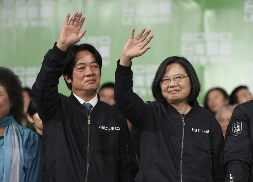 Taiwan's 2020 presidential election candidate, Taiwanese President Tsai Ing-wen, right, and her running mate William Lai celebrate their victory with supporters in Taipei, Taiwan, Saturday, Jan. 11, 2020. (AP Photo/Chiang Ying-ying)