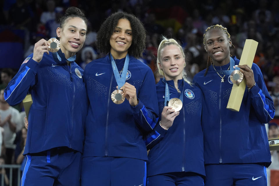 The United States 3x3 basketball team displays their bronze medals during the medal ceremony at the 2024 Summer Olympics, Monday, Aug. 5, 2024, in Paris, France. (AP Photo/Frank Franklin II)